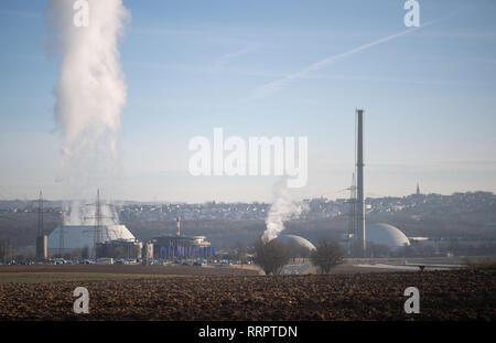 Neckarwestheim, Germany. 26th Feb, 2019. Steam comes from the cooling tower of unit 2 of the Neckarwestheim nuclear power plant, next to which are units 1 (M) and 2 (r). Based on a fictitious severe accident at the Neckarwestheim nuclear power plant, federal and state authorities are practicing radiological disaster control. Credit: Marijan Murat/dpa/Alamy Live News Stock Photo