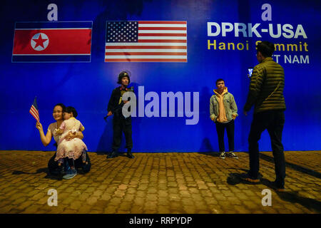 Hanoi, Vietnam. 27th Feb, 2019. People pose for pictures in front of the DPRK-USA Hanoi Summit sign board ahead of the Trump Kim two-day summit from February 27-28. Credit: Christopher Jue/ZUMA Wire/Alamy Live News Stock Photo