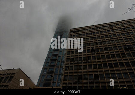 Kolkata, WEST BENGAL, India. 26th Feb, 2019. The iconic building of kolkata, THE 42 is seen covered with dense smoke & cloud during rain.Due to a depression and Western Disturbance kolkata and other parts of Bengal faced light to Moderate Rain with Thunderstorm which is affecting daily life. Credit: Avishek Das/SOPA Images/ZUMA Wire/Alamy Live News Stock Photo