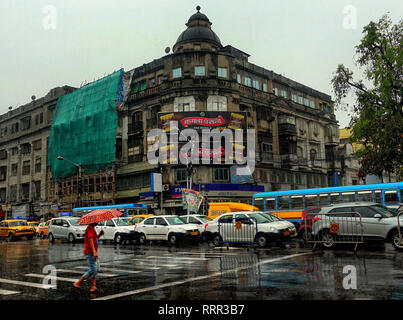 Kolkata, WEST BENGAL, India. 26th Feb, 2019. A man seen walking with an Umbrella on the busy street of kolkata during Rain.Due to a depression and Western Disturbance kolkata and other parts of Bengal faced light to Moderate Rain with Thunderstorm which is affecting daily life. Credit: Avishek Das/SOPA Images/ZUMA Wire/Alamy Live News Stock Photo