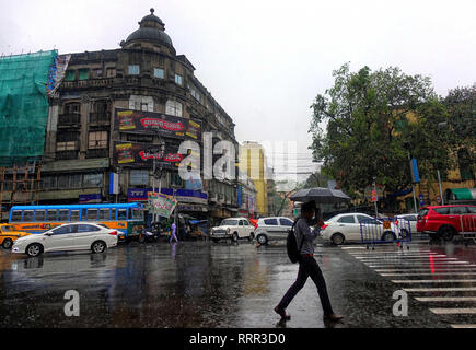 Kolkata, WEST BENGAL, India. 26th Feb, 2019. A man seen walking with an Umbrella on the busy street of kolkata during Rain.Due to a depression and Western Disturbance kolkata and other parts of Bengal faced light to Moderate Rain with Thunderstorm which is affecting daily life. Credit: Avishek Das/SOPA Images/ZUMA Wire/Alamy Live News Stock Photo