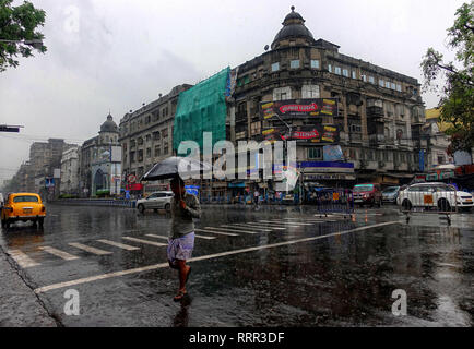 Kolkata, WEST BENGAL, India. 26th Feb, 2019. A man seen walking with an Umbrella on the busy street of kolkata during Rain.Due to a depression and Western Disturbance kolkata and other parts of Bengal faced light to Moderate Rain with Thunderstorm which is affecting daily life. Credit: Avishek Das/SOPA Images/ZUMA Wire/Alamy Live News Stock Photo