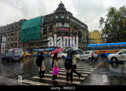 Kolkata, WEST BENGAL, India. 26th Feb, 2019. People seen walking with Umbrellas on the busy street of kolkata during Rain.Due to a depression and Western Disturbance kolkata and other parts of Bengal faced light to Moderate Rain with Thunderstorm which is affecting daily life. Credit: Avishek Das/SOPA Images/ZUMA Wire/Alamy Live News Stock Photo