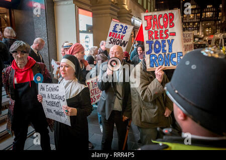Protesters from Class War anarchist group hold a lively demonstration outside the London Palladium theatre against the evening talk featuring Jacob Rees-Mogg, Conservative MP and prominent Brexit supporter. Class War members, including long-time anarchist, Ian Bone (with megaphone), Jane Nicholl (dressed as a nun) and Adam Clifford (as Rees-Mogg parody) claim Mr Rees-Mogg, a Catholic, is a religious extremist because of his outspoken views on abortion. Stock Photo