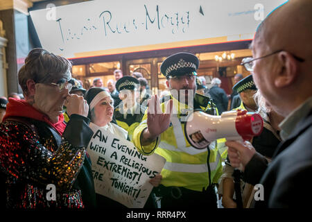 Protesters from Class War anarchist group hold a lively demonstration outside the London Palladium theatre against the evening talk featuring Jacob Rees-Mogg, Conservative MP and prominent Brexit supporter. Class War members, including long-time anarchist, Ian Bone (pictured with megaphone), Jane Nicholl (dressed as a nun) and Adam Clifford (pictured left as Rees-Mogg parody) claim Mr Rees-Mogg, a Catholic, is a religious extremist because of his outspoken views on abortion. Stock Photo