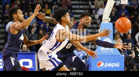 Amherst, New York, USA. 26th Feb 2019. Akron Zips guard Jimond Ivey (0) defends against Buffalo Bulls guard Ronaldo Segu (10) during the first half of play in the NCAA Basketball game between the Akron Zips and Buffalo Bulls at Alumni Arena in Amherst, N.Y. (Nicholas T. LoVerde/Cal Sport Media) Credit: Cal Sport Media/Alamy Live News Stock Photo