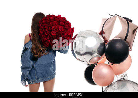Brunette girl with long hair getting presents on birthday. Stock Photo