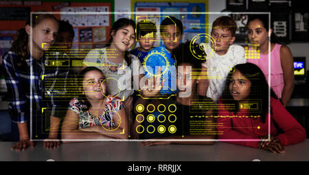 Junior high school students using futuristic touch screen in classroom Stock Photo
