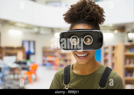 Portrait playful junior high girl student wearing virtual reality glasses Stock Photo