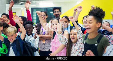 Portrait enthusiastic junior high students and teachers cheering Stock Photo