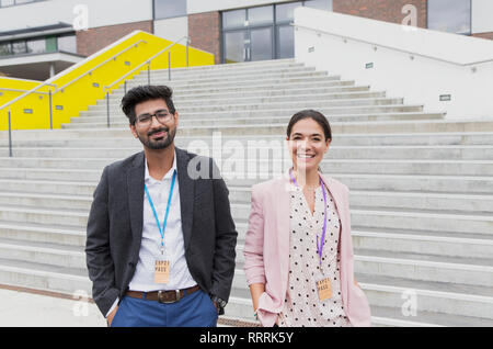 Portrait confident teachers standing outside school building steps Stock Photo