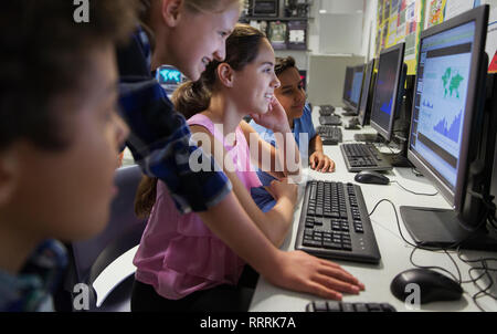 Junior high school students using computer in classroom Stock Photo