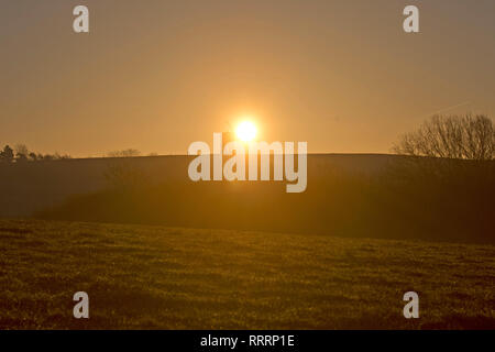 The Sun rises behind Chesterton Windmill in Warwickshire on 26 February 2019. Stock Photo