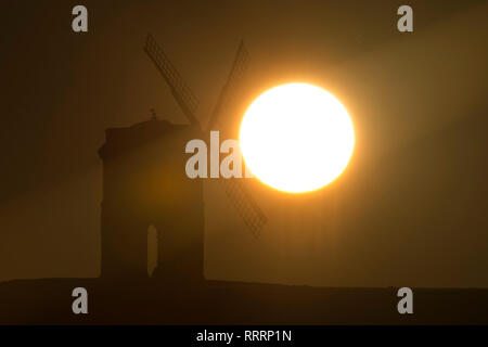 The Sun rises behind Chesterton Windmill in Warwickshire on 26 February 2019. Stock Photo