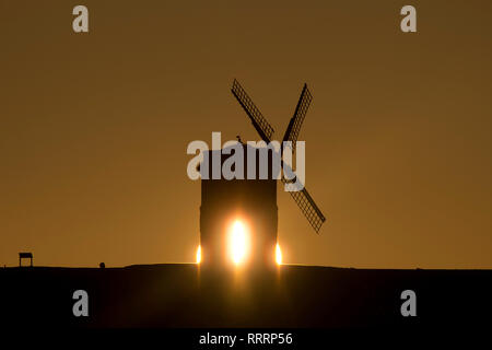 The Sun rises behind Chesterton Windmill in Warwickshire on 26 February 2019. Stock Photo