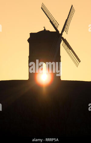 The Sun rises behind Chesterton Windmill in Warwickshire on 26 February 2019. Stock Photo