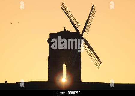 The Sun rises behind Chesterton Windmill in Warwickshire on 26 February 2019. Stock Photo