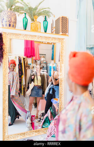 Young women friends shopping in clothing store Stock Photo