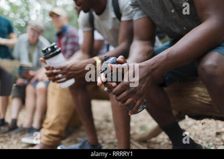 Close up male hikers resting with water bottles Stock Photo