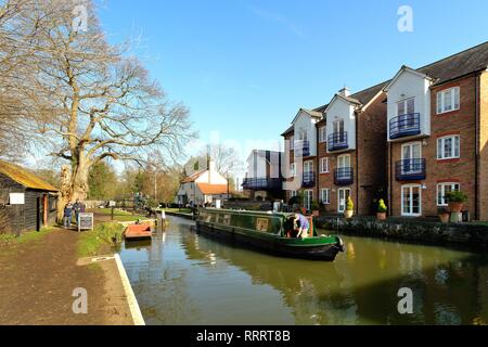 A narrow boat passing through the Thames lock which connects the River Thames to the Wey canal navigation, Weybridge Surrey England UK Stock Photo