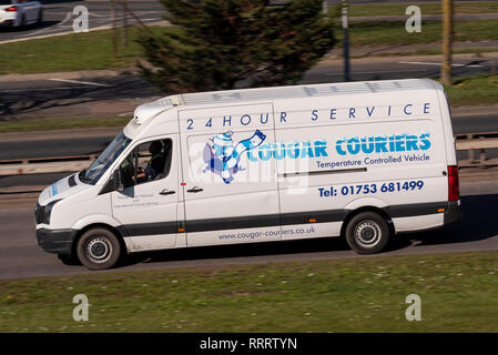 Cougar Couriers vehicle van driving on the road near Heathrow, London ...