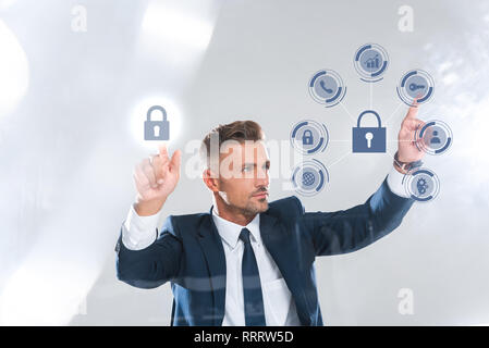 handsome businessman moving security icons isolated on white, artificial intelligence concept Stock Photo