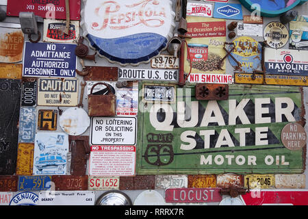 Along the famous Route 66 highway there are many unique sites, in Albuquerque a store has a wall of old car and travel signs. Stock Photo