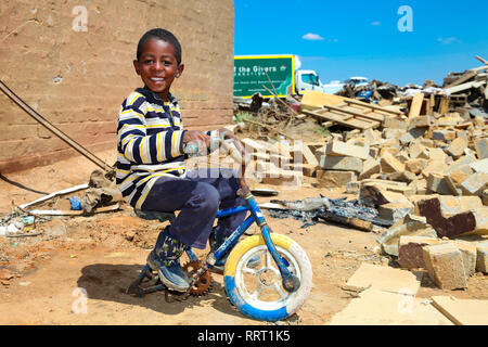 Johannesburg, South Africa - October 04 2011: African Boy in a Tornado damaged Township Stock Photo