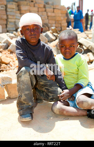 Johannesburg, South Africa - October 04 2011: African Children in a Tornado damaged Township Stock Photo