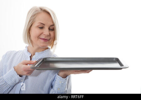 Kitchen woman waitress gives empty tray for your advertising products isolated on white background. Mock up for use Stock Photo