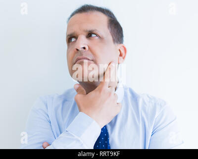 Middle age man thinking clueless about a question Stock Photo