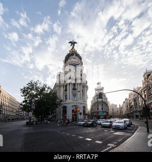 Cars waiting for traffic-light at the street cross Calle de Alcala and Gran Via at sunny evening in Madrid, Spain Stock Photo