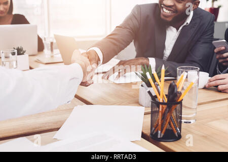 Business partnership. Men shaking hands after signing deal Stock Photo