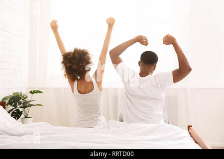 https://l450v.alamy.com/450v/rrtd00/funny-married-couple-stretching-in-bedroom-after-wakeup-rrtd00.jpg