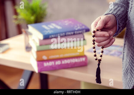 Male hand holding a string of beards Stock Photo