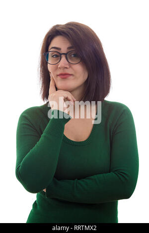 Arrogant and skeptic young woman holding hand under chin looking to camera isolated over white background. Stock Photo