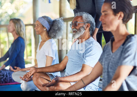 Serene senior man meditating during yoga retreat Stock Photo