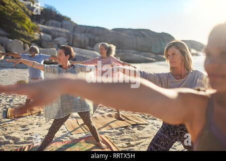 Woman stretching during yoga on road along the sea. Fit woman