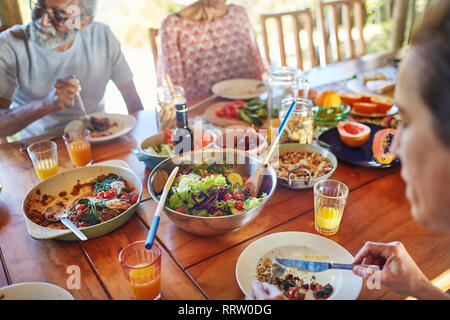 Friends eating healthy meal during yoga retreat Stock Photo