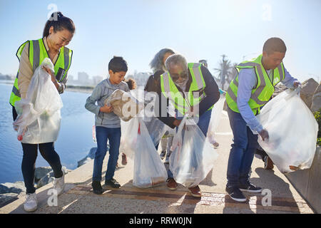 Volunteers cleaning up waterfront litter Stock Photo