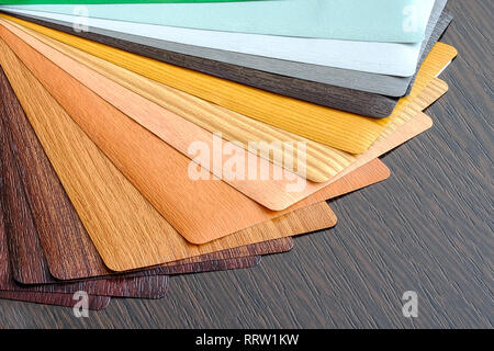 Lamination samples. On a wooden background for lamination of any wooden and plastic products used in construction Stock Photo