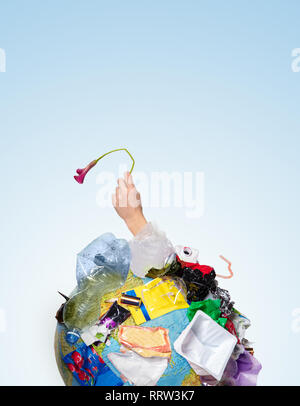 An earth globe covered with trash and male hand with a withering flower over white background, the concept of ecology problem and World Environment Day. Photo with message for social advertising, place for inscription Stock Photo