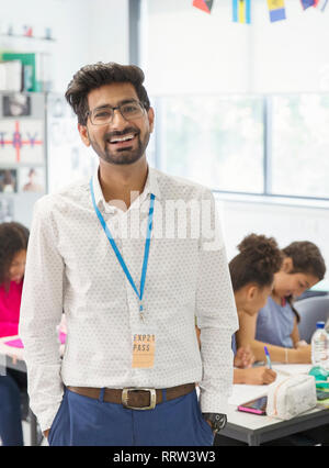 Portrait happy male teacher in classroom Stock Photo