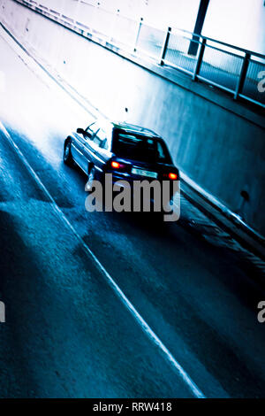 blue car in an underpass, slow shutter effect Stock Photo