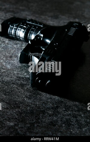 black gun in dramatic light - image for thriller book cover Stock Photo