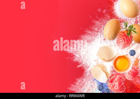 Cooking ingredients for muffins, cookies, dough and pastry. Photomontage Flat lay with eggs, flour, sugar and berries. Top view Stock Photo