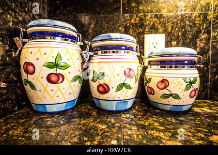 Three Kitchen Canisters On Granite Counter Stock Photo