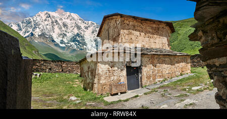 The medieval Georgian Orthodox St George Church “JGRag” with mount Shkhara (5193m) behind, Ushguli, Upper Svaneti, Samegrelo-Zemo Svaneti, Mestia, Geo Stock Photo