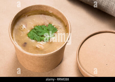 Soup in a disposable cup of craft paper Stock Photo
