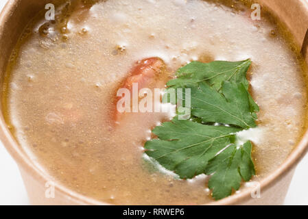 Soup in a disposable cup of craft paper Stock Photo